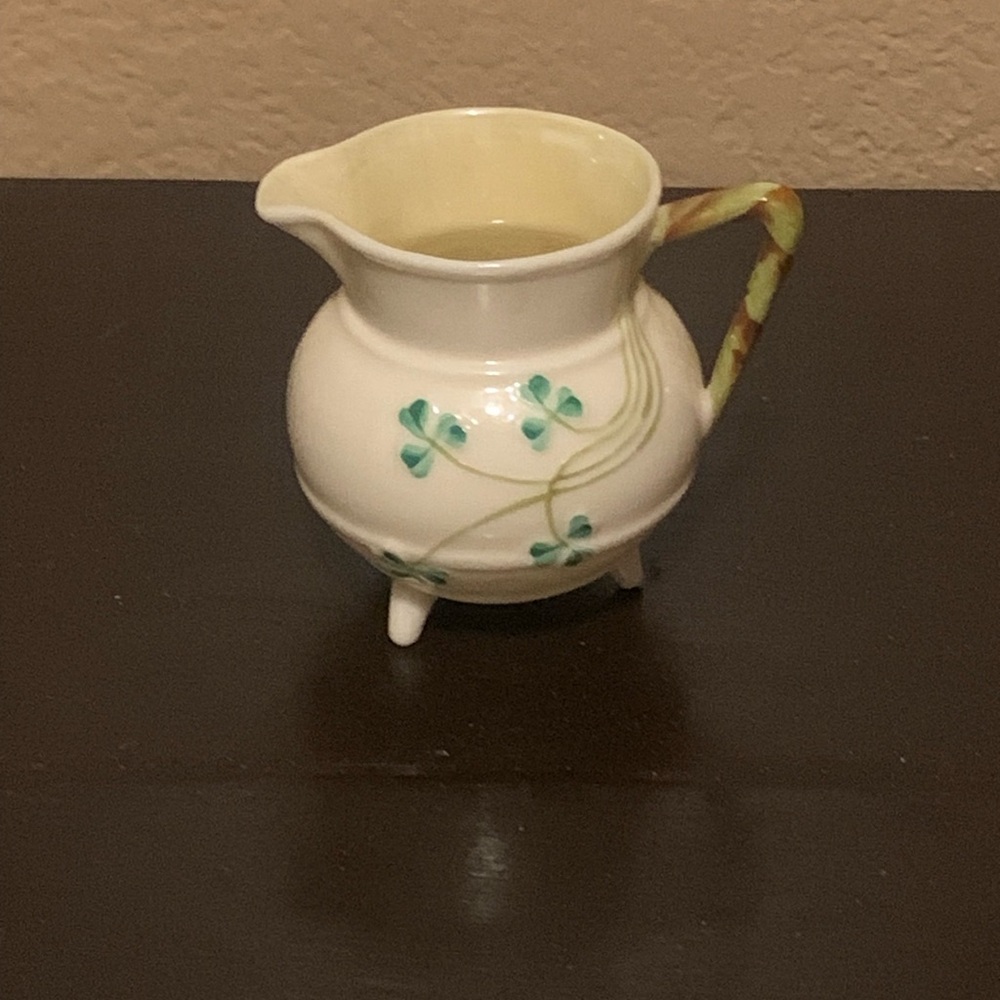 This is a vintage Belleek three-footed Shamrock creamer made of Parian china